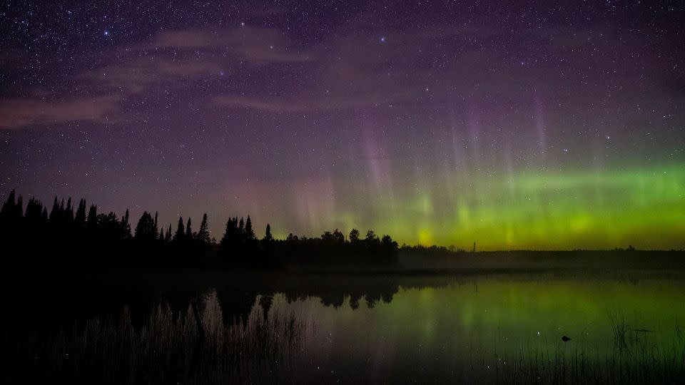 The aurora borealis can be seen on the north horizon in the night sky over Wolf Lake in the Cloquet State Forest in Minnesota in September 2019. - Alex Kormann/Star Tribune/Getty Images