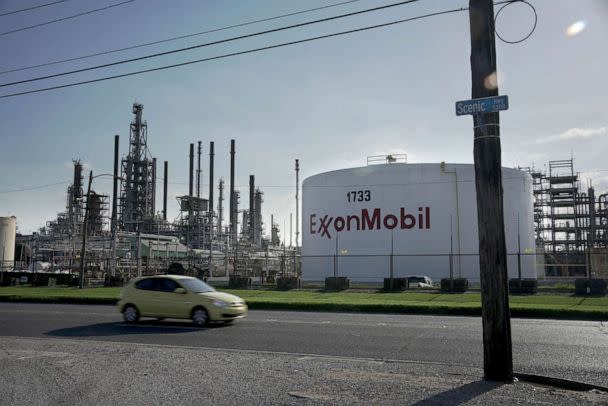 PHOTO: A car drives past the ExxonMobil Baton Rouge Refinery in Baton Rouge, La., May 15, 2021. (Kathleen Flynn / Reuters, FILE)