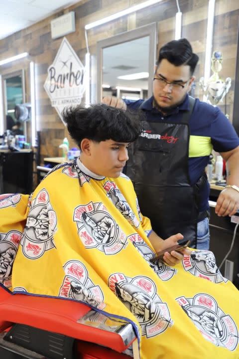 Angel Gonzalez, 16, getting his Edgar cut touched up by Harlingen barber Eybard Hernandez (Rolando Avila/NEXSTAR)