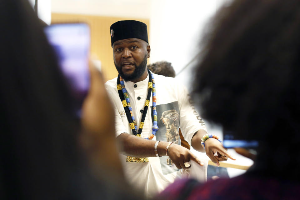 Congolese activist Mwazulu Diyabanza talk to the media at the Palais de Justice courthouse, in Paris, Wednesday, Sept. 30, 2020. The controversial Congolese activist and four others are going on trial Wednesday on aggravated theft charges for trying to remove a 19th century African funeral pole from a Paris museum, in a protest against colonial-era plundering of African art. (AP Photo/Thibault Camus)