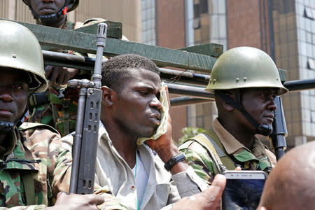 A supporter of the opposition National Super Alliance (NASA) coalition is detained after riot policemen dispersed protesters during a demonstration calling for the removal of Independent Electoral and Boundaries Commission (IEBC) officials in Nairobi, Kenya September 26, 2017. REUTERS/Thomas Mukoya