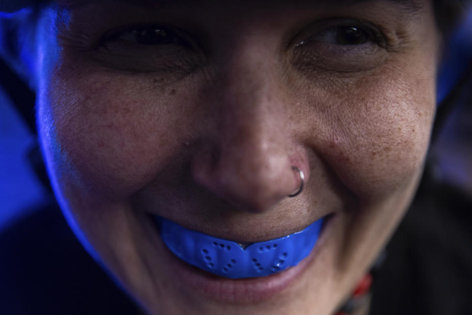 A member of the Long Island Roller Rebels, wears a mouthguard for a practice, Tuesday, March 19, 2023, at United Skates of America in Seaford, N.Y. (AP Photo/Jeenah Moon)