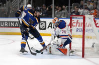 St. Louis Blues' Alexey Toropchenko (13) is unable to score past Edmonton Oilers goaltender Stuart Skinner (74) during the second period of an NHL hockey game Monday, April 1, 2024, in St. Louis. (AP Photo/Jeff Roberson)