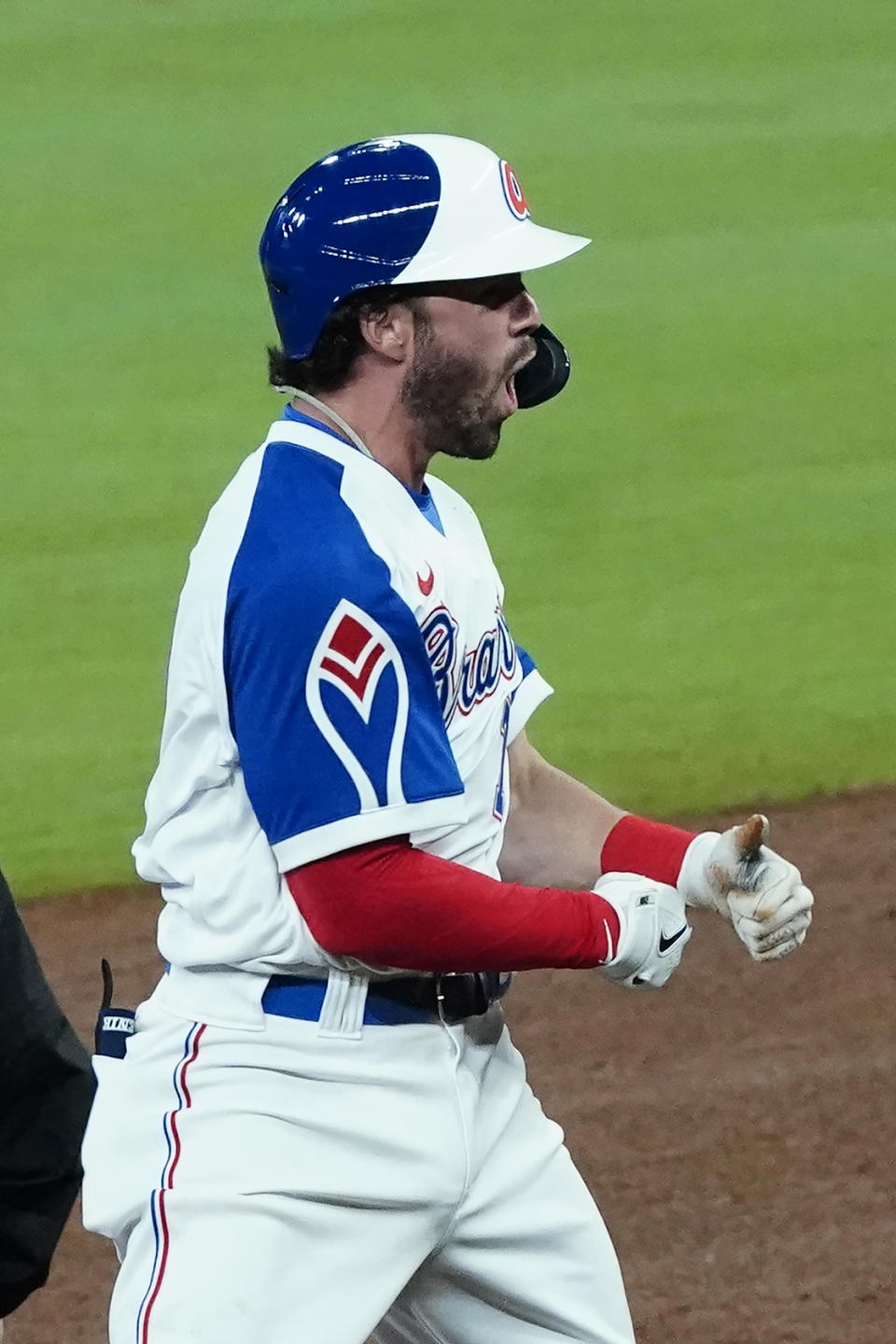 Atlanta Braves' Dansby Swanson (7) reacts after driving in a run with a double In the sixth inning of a baseball game against the Philadelphia Phillies, Saturday, April 10, 2021, in Atlanta. (AP Photo/John Bazemore)