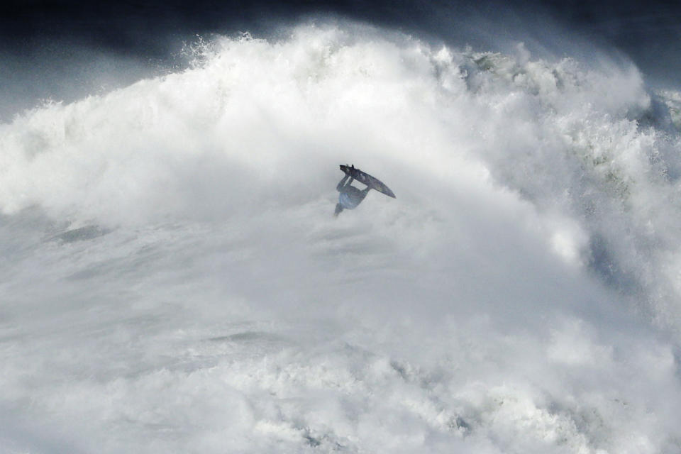 Kai Lenny from Hawaii goes airborne exiting a wave during the Nazare Tow Surfing Challenge at Praia do Norte or North Beach in Nazare, Portugal, on Feb. 11, 2020. (AP Photo/Armando Franca)