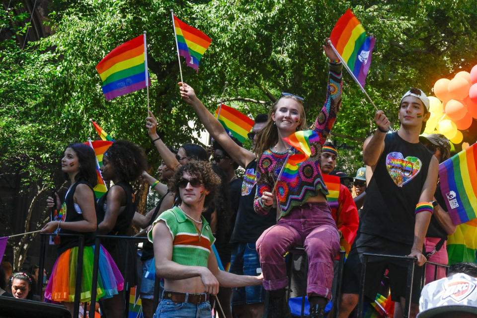 People waving flags on a pride float in New York City