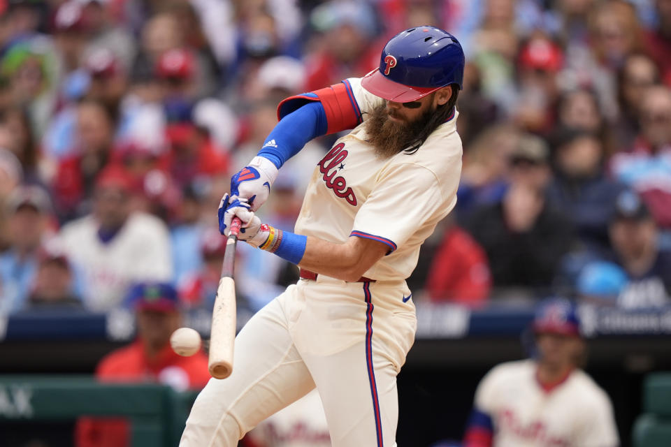 Philadelphia Phillies' Brandon Marsh hits a run-scoring single against Chicago White Sox pitcher Nick Nastrini during the first inning of a baseball game, Sunday, April 21, 2024, in Philadelphia. (AP Photo/Matt Slocum)