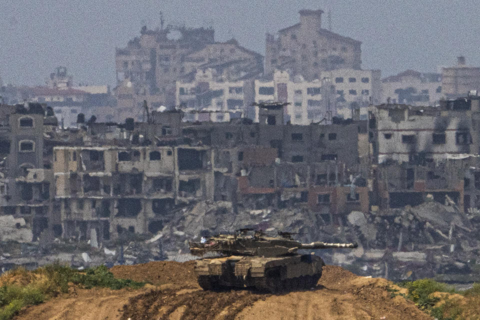 Israeli soldiers on a tank on a position on the border with Gaza Strip, in southern Israel, Tuesday, March 19, 2024. (AP Photo/Ariel Schalit)