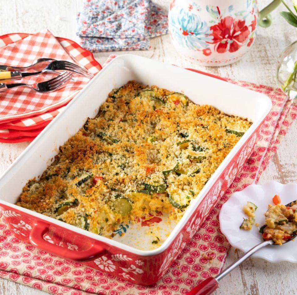 cheesy zucchini casserole in red baking dish