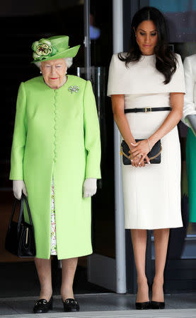 Britain's Queen Elizabeth and Meghan, the Duchess of Sussex, observe a moment of silence in memory of the victims of the Genfell Tower fire during their visit to Chester, June 14, 2018. REUTERS/Phil Noble/Pool