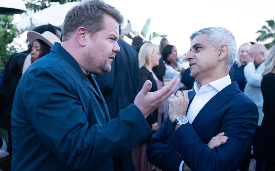 Sadiq Khan chats to the actor James Corden, a friend of the Sussexes, at a rooftop party at Holloway House, part of the Soho House empire, in Hollywood, California, during his five day visit to the US - Stefan Rousseau/PA