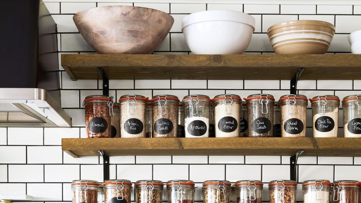 a kitchen with shelves with jars