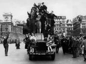 <p>Servicemen and citizens rejoice by way of riding a truck through the streets of London.</p>