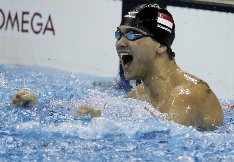 Singapore's Joseph Schooling celebrates after winning gold in the men's 100-meter butterfly final during the swimming competitions at the 2016 Summer Olympics, Friday, Aug. 12, 2016, in Rio de Janeiro, Brazil. (AP Photo/Julio Cortez)