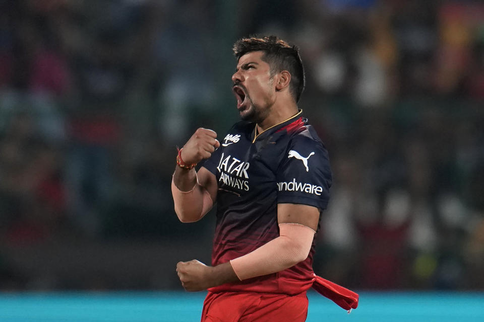 Royal Challengers Bangalore's Karn Sharma celebrates the dismissal of Mumbai Indians' Tim David during the Indian Premier League cricket match between Royal Challengers Bangalore and Mumbai Indians in Bengaluru, India, Sunday, April 2, 2023. (AP Photo/Aijaz Rahi)