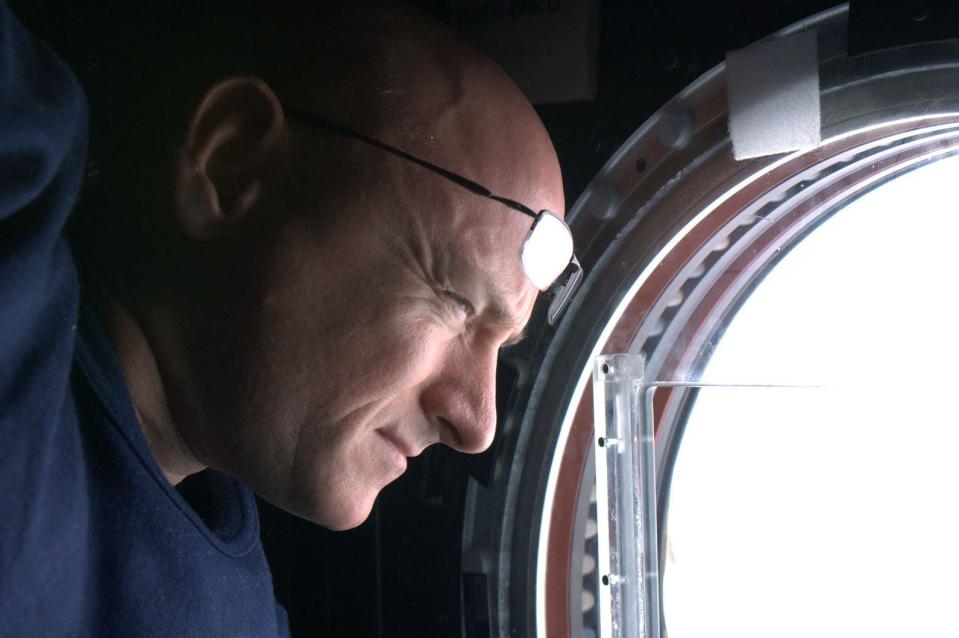 Scott Kelly peers out one of the International Space Station’s windows during his year in orbit in 2015.