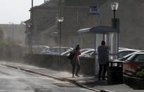 People struggling in the wind in Troon in Ayrshire. (PA)