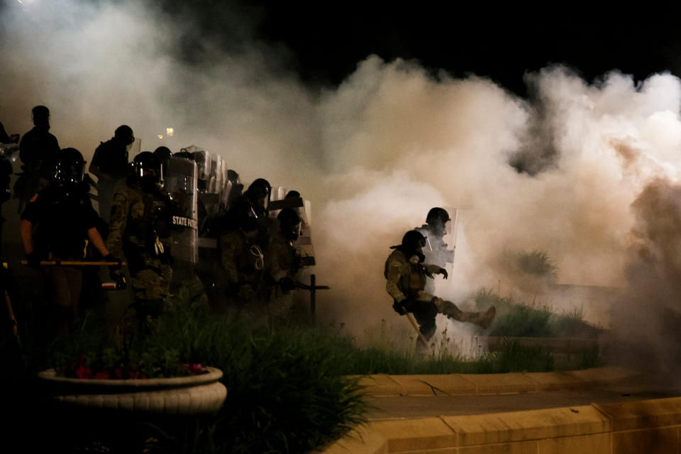 Image: Officers stand in a cloud of tear gas as protesters retreat on the steps of the Iowa State Capitol on May 30, 2020 in Des Moines. (Brian Powers / The Register via USA-Today Network)