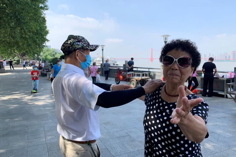 People dance by the Yangtze river following the coronavirus disease (COVID-19) outbreak in Wuhan