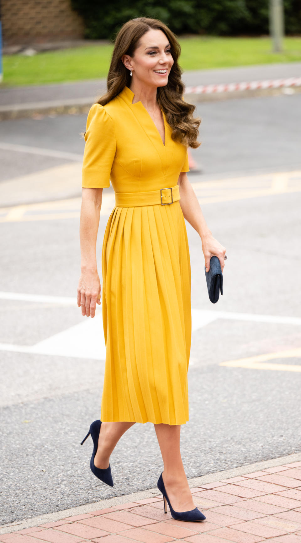 kate middleton wearing yellow dress and black heels, The Princess of Wales visits the Royal Surrey County Hospital's Maternity Unit on October 05, 2022 in Guildford, England. (Photo by Samir Hussein/WireImage)