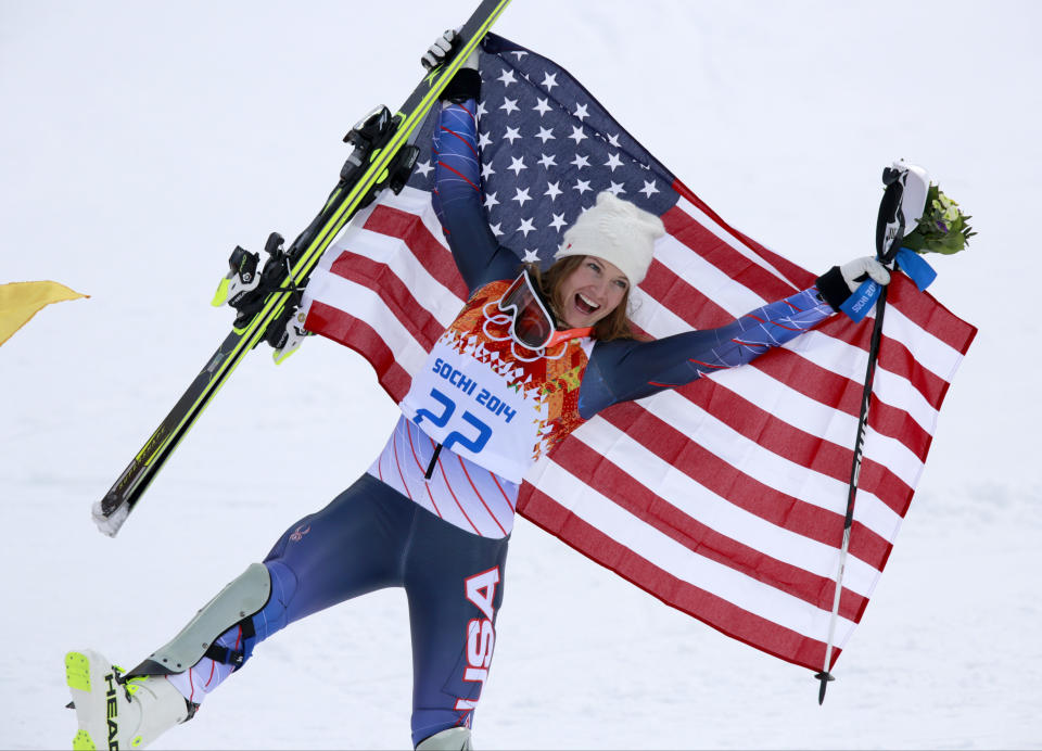 Women's supercombined bronze medalist United States' Julia Mancuso poses with the U.S. flag after a flower ceremony at the Alpine ski venue in the Sochi 2014 Winter Olympics, Monday, Feb. 10, 2014, in Krasnaya Polyana, Russia. (AP Photo/Gero Breloer)