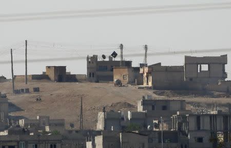 A black flag belonging to the Islamic State is seen in the Syrian town of Kobani, as pictured from the Turkish-Syrian border near the southeastern town of Suruc October 9, 2014. REUTERS/Umit Bektas