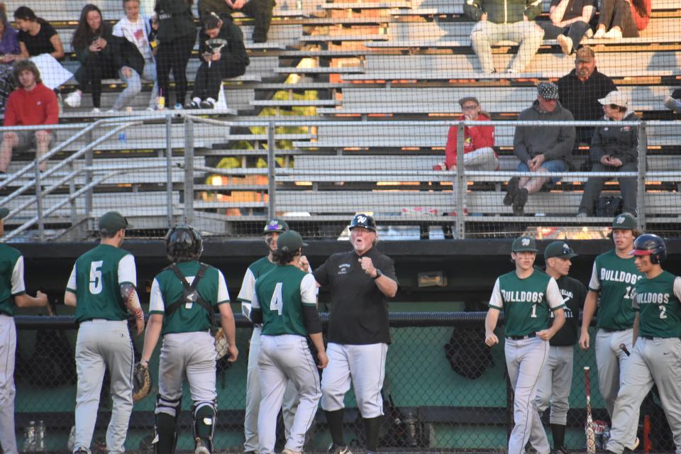 Westmoreland Coach Paul Engelhart greets his team after a half inning during Saturday's win