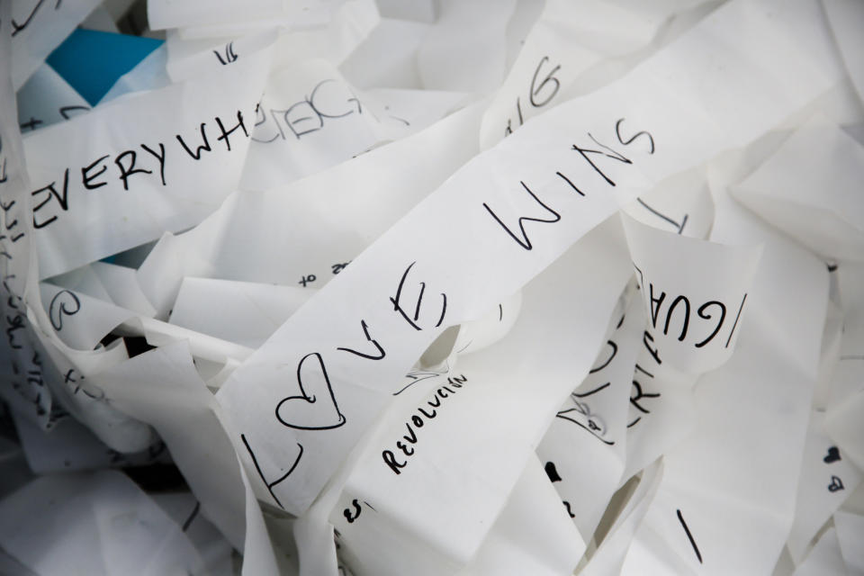 Streamers with written messages as part of the skynet artwork 'Visions In Motion' lay on the ground prior to the setup of the artwork at the 'Strasse des 17. Juni' (Street of June 17) boulevard in front of the Brandenburg Gate in Berlin, Germany, Friday, Nov. 1, 2019. The art work by Patrick Shearn was made with about 100.000 streamers with written messages and is part of the celebrations marking the 30th anniversary of the fall of the Berlin Wall on Nov 9, 2019. (AP Photo/Markus Schreiber)