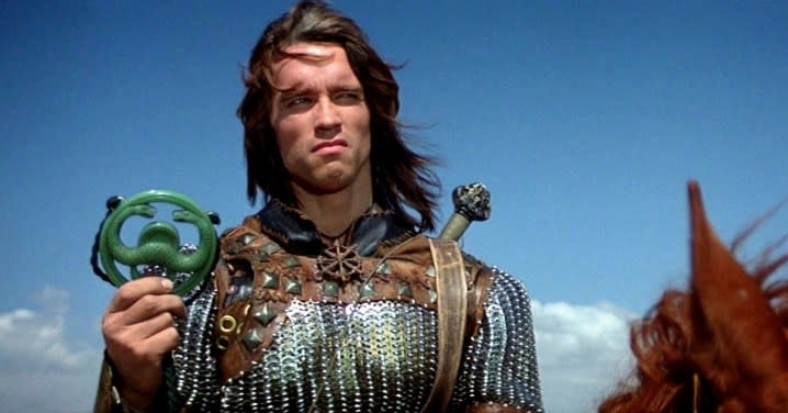 Conan holds a metal symbol in 1982's Conan The Barbarian.