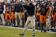 Oklahoma State coach Mike Gundy gestures during the second half of the team's NCAA college football game against Oklahoma, Saturday, Nov. 27, 2021, in Stillwater, Okla. (AP Photo/Sue Ogrocki)