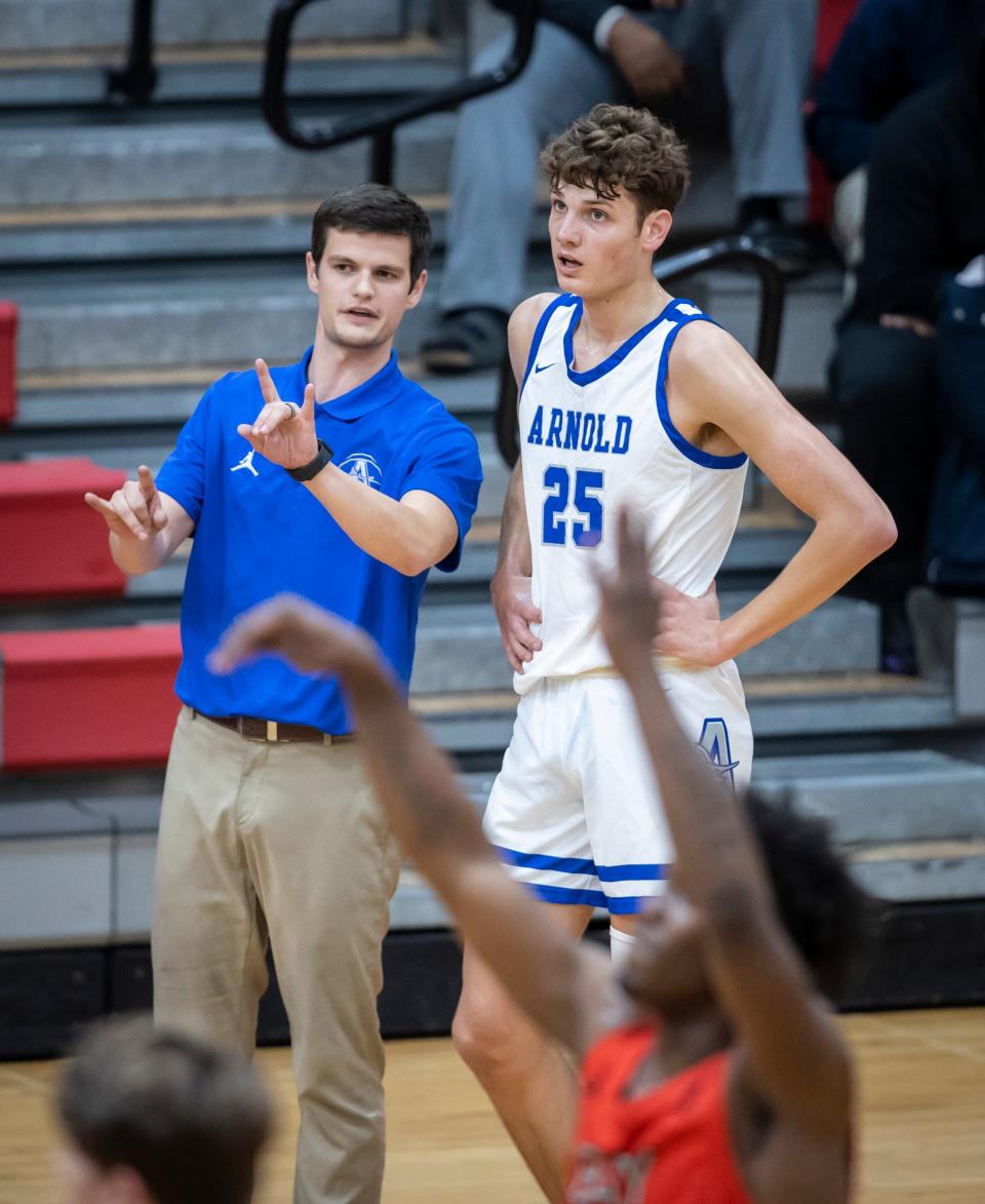 Arnold coach Josh Laatsch talks with center Alex Steen during a free throw attempt. Bay High hosted Arnold in a boys basketball game Friday, February 4, 2022. 