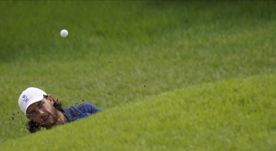 Tommy Fleetwood of Great Britain plays a shot from a bunker on the 9th hole during the second round of the men's golf event at the 2020 Summer Olympics on Friday, July 30, 2021, at the Kasumigaseki Country Club in Kawagoe, Japan. (AP Photo/Matt York)