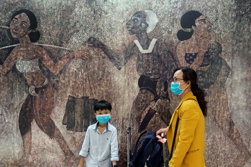 Chinese tourists wearing protective masks are pictured at Bangkok's Suvarnabhumi international airport in Thailand