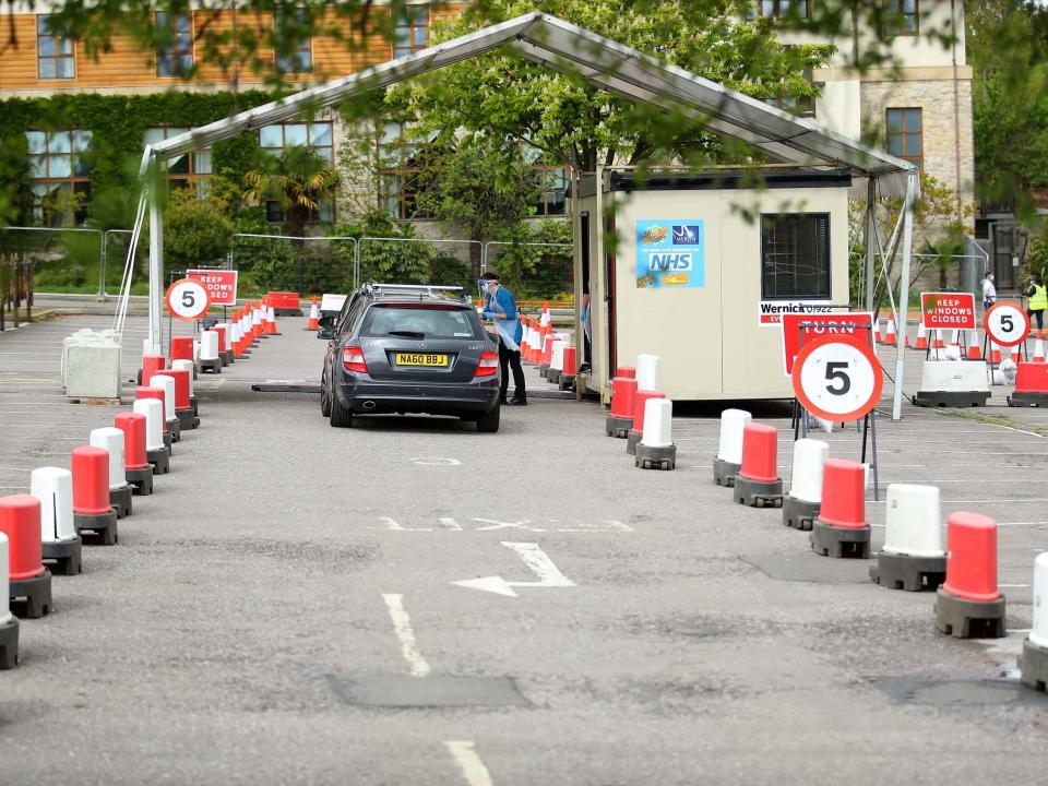 Cars are parked awaiting a swap test at a coronavirus drive-through testing centre in a car park in London: Getty Images