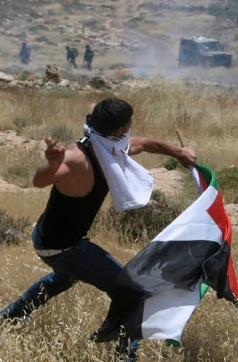 Palestinian protestors clash with Israeli forces following a demonstration against Israeli settlements in the West Bank village of Dair al-Hatab, east of Nablus in June 2011. Israel is willing to begin new Middle East peace talks using the 1967 lines as a basis for negotiations if the Palestinians drop their UN membership bid, an Israeli government official confirmed on Tuesday