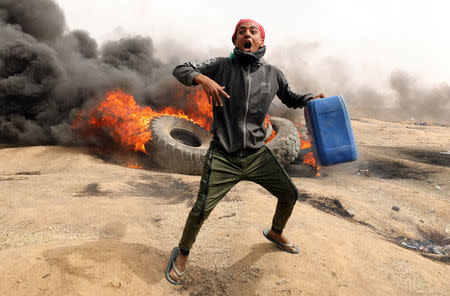 A demonstrator shouts during clashes with Israeli troops at a protest at the Israel-Gaza border where Palestinians demand the right to return to their homeland, east of Gaza City April 20, 2018. REUTERS/Mohammed Salem