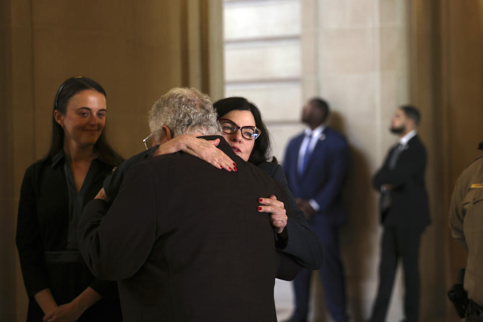 U.S. Sen. Dianne Feinstein's granddaughter Eileen Marino, left, and daughter Katherine Feinstein share a moment at San Francisco City Hall before a public viewing in San Francisco, on Wednesday, Oct. 4, 2023. Feinstein, who died Sept. 29, served as San Francisco's mayor. (Gabrielle Lurie/San Francisco Chronicle via AP, Pool)