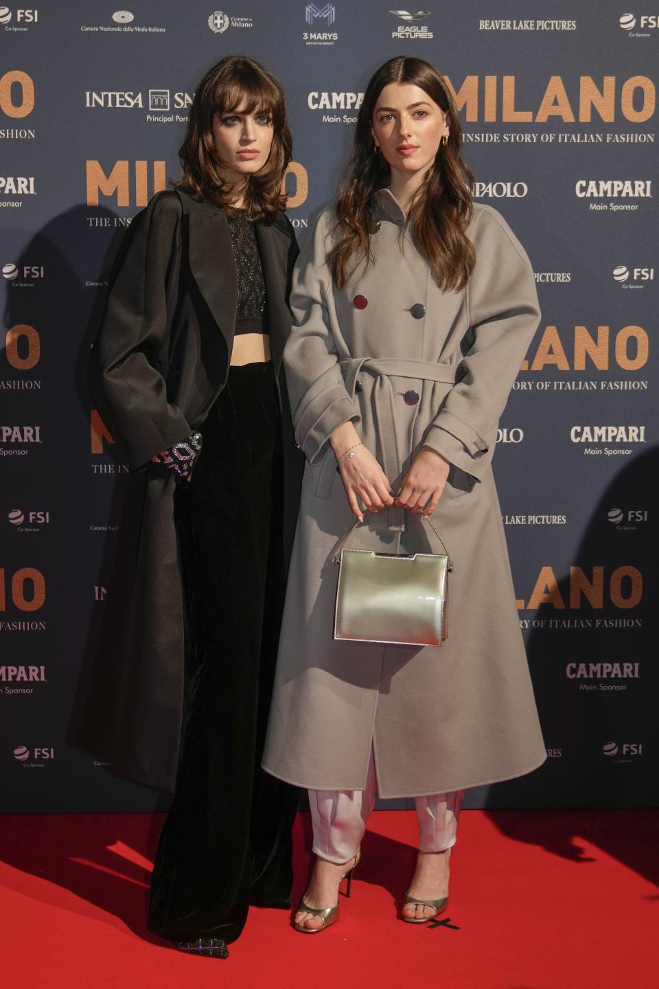 Greta Ferro, left, and Kyra Kennedy pose for photographers upon arrival for the premiere of the film 'Milano, the inside story of Milan Fashion' in Milan, Italy, Sunday, Feb. 26, 2023. (AP Photo/Luca Bruno)