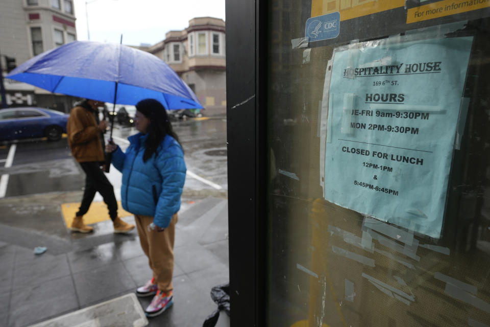 Windy Click, director of community engagement, greets people at the entrance to the Hospitality House in San Francisco, Wednesday, Feb. 7, 2024. A measure aimed at transforming how California spends money on mental health will go before voters in March as the state continues to grapple with an unabated homelessness crisis. Hospitality House's programs are among a slew of prevention services that would face significant budget cuts if Proposition 1 passes. (AP Photo/Eric Risberg)