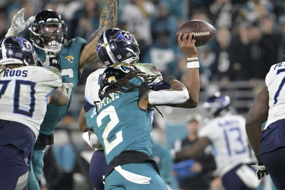 Tennessee Titans quarterback Joshua Dobbs fumbles as he is hit by Jacksonville Jaguars safety Rayshawn Jenkins (2), resulting in Jacksonville returning the fumble for a touchdown, in the second half of an NFL football game, Saturday, Jan. 7, 2023, in Jacksonville, Fla. (AP Photo/Phelan M. Ebenhack)