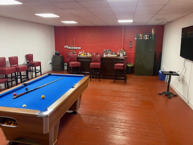 Seven men have been fined £200 each after they were caught drinking in a pop-up pub - complete with a pool table, beer taps and football on the TV (swns)