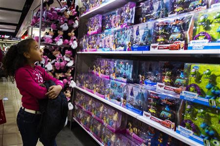 A girl looks up at a toy sales display in a JC Penney store in New York in this November 29, 2013 file photo. REUTERS/Lucas Jackson/Files