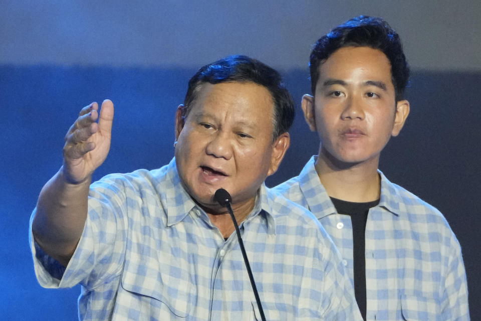 FILE - Presidential candidate Prabowo Subianto, left, delivers a speech as his running mate Gibran Rakabuming Raka, the eldest son of Indonesian President Joko Widodo, listens during a gathering with supporters and members of their campaign team in Jakarta, Indonesia, Wednesday, Feb. 14, 2024. Subianto’s rise as Indonesia’s apparent next president is a dramatic comeback from a notorious past, which saw the United States banning his entry over human rights and the Indonesian army, where he led the special forces, expelling him. (AP Photo/Vincent Thian, File)