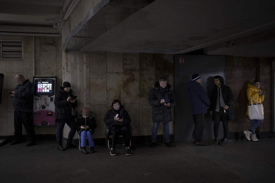 FILE - People use their phones while they gather in a metro station during an air raid alarm, in Kyiv, Ukraine, Wednesday, Dec. 21, 2022. When air raid alarms sound in Ukraine, they also trigger a downloadable app that has been voiced by “Star Wars” actor Mark Hamill. With his gravely but also calming baritone, he urges people to take cover. He also tells them when the danger has passed, signing off with “May the Force be with you.” In an interview with The Associated Press, the actor said he’s admiring Ukraine's resilience from afar in California. (AP Photo/Felipe Dana, File)