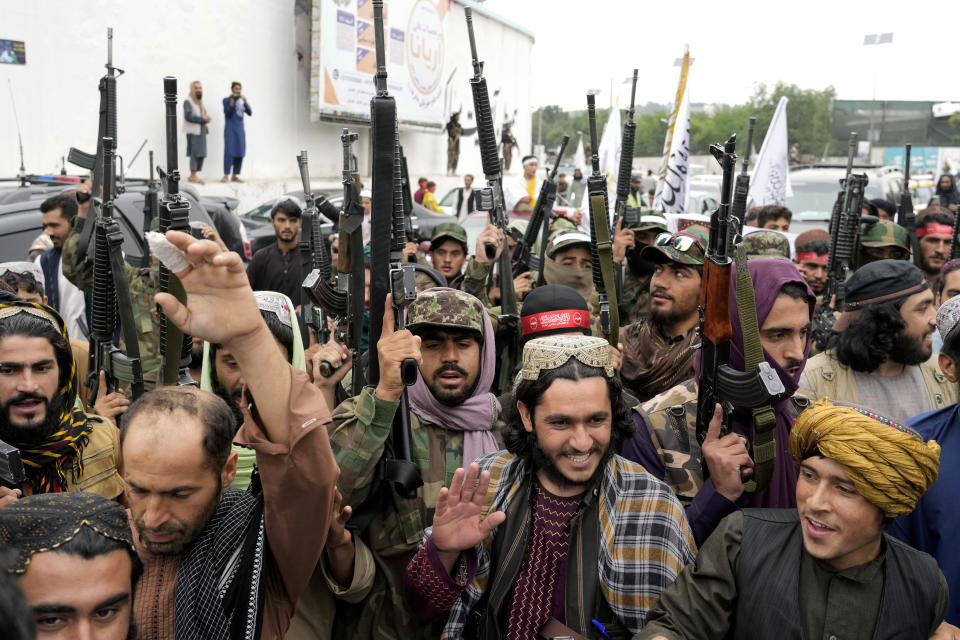 Taliban fighters celebrate one year since they seized the Afghan capital, Kabul, in front of the U.S. Embassy in Kabul, Afghanistan, Monday, Aug. 15, 2022. The Taliban marked the first-year anniversary of their takeover after the country's western-backed government fled and the Afghan military crumbled in the face of the insurgents' advance. (AP Photo/Ebrahim Noroozi)