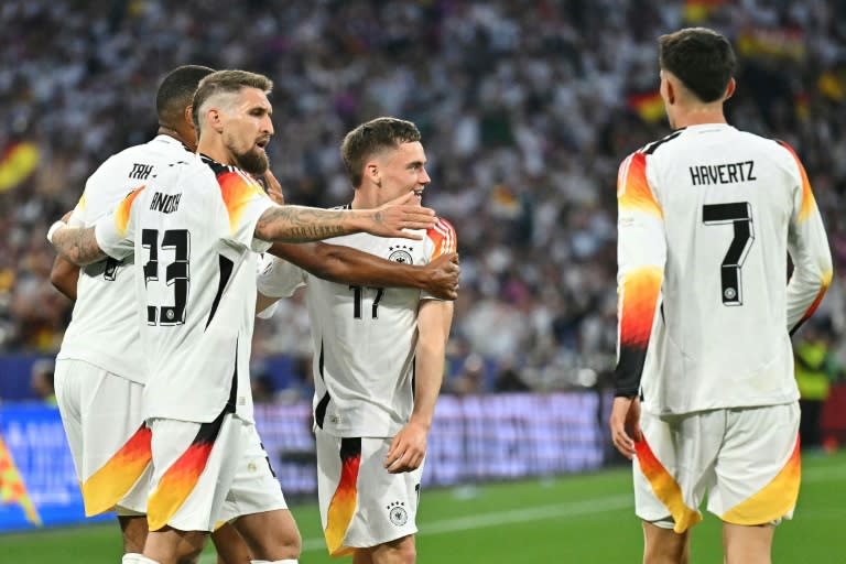 First strike: Germany's Florian Wirtz (C) celebrates after scoring his team's first goal (MIGUEL MEDINA)