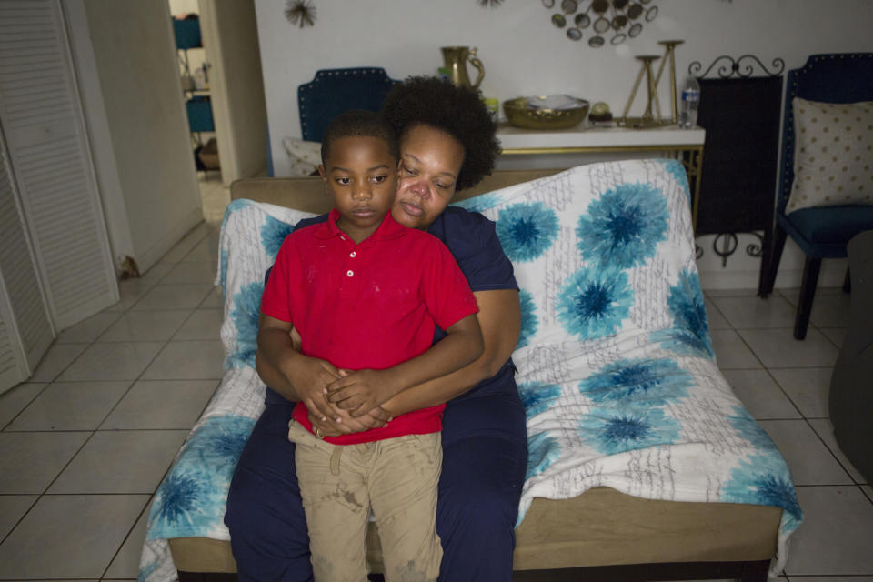 In this Nov. 4, 2019 photo, Kina Phillips holds her 5-year-old grandson Jamal Tillman, at their home in South Bay, Fla. Phillips says Florida's annual sugar cane burning season is difficult for Tillman, whose immune system suffers and asthma worsens during burns. (AP Photo/Ellis Rua)