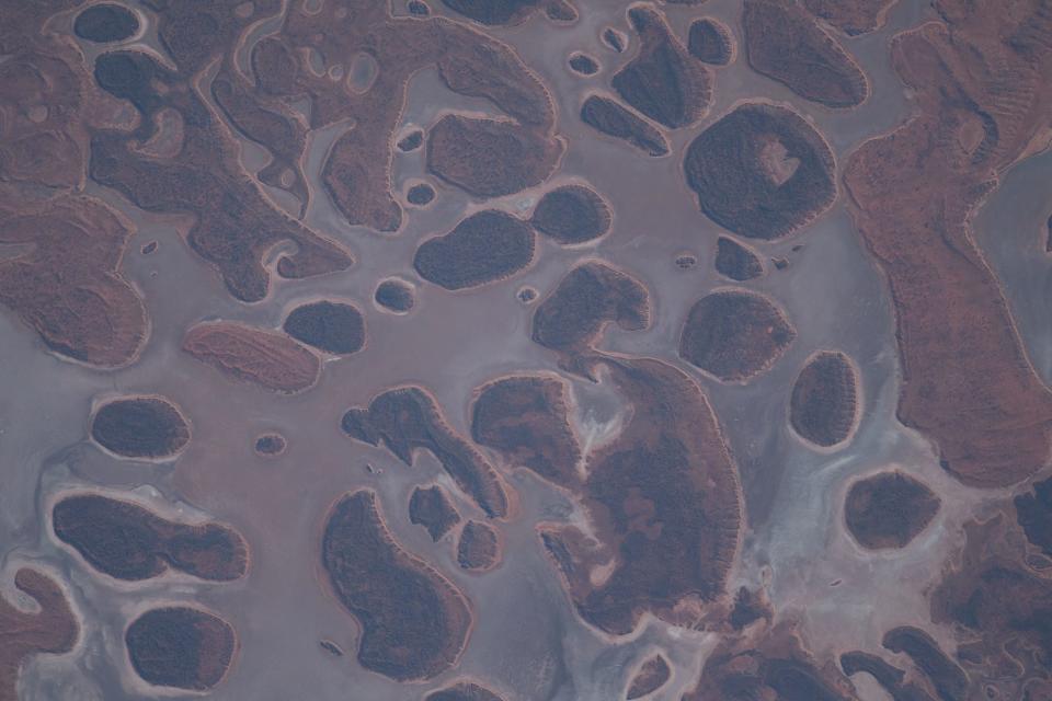 brown desert covered in islands of rust-colored or shrubby land