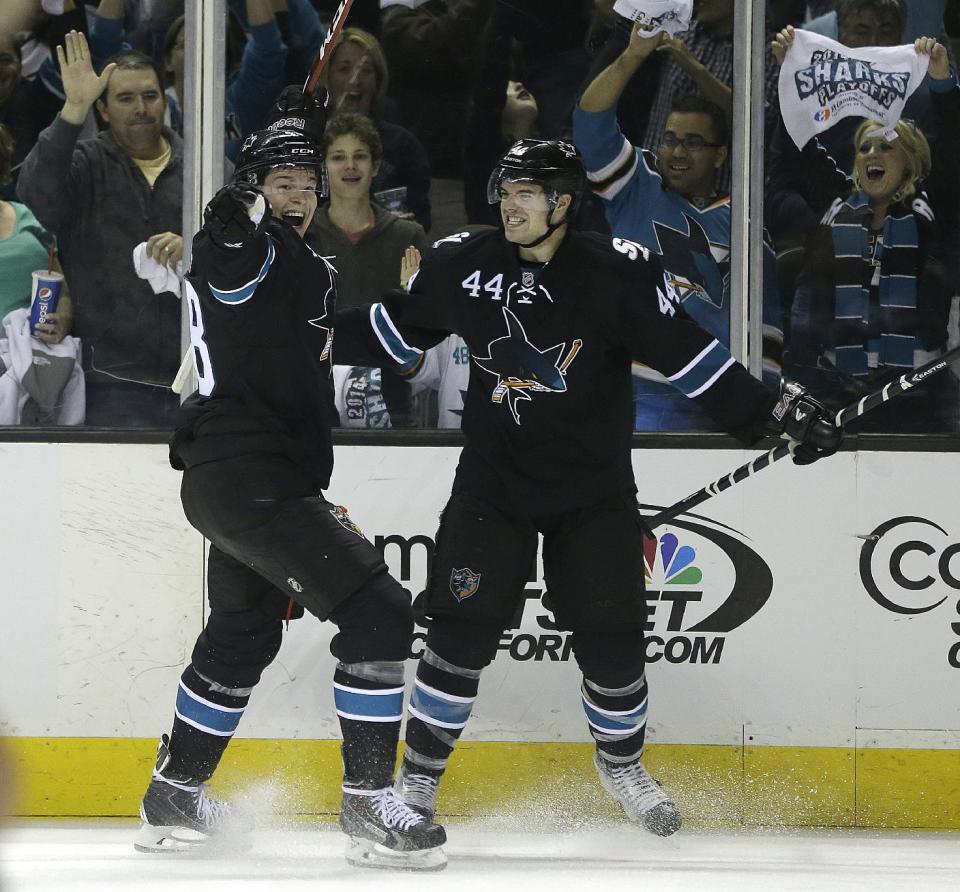 San Jose Sharks' Marc-Edouard Vlasic (44) celebrates with Joe Pavelski, left, after Vlasic scored against the Los Angeles Kings during the second period of Game 1 of an NHL hockey first-round playoff series Thursday, April 17, 2014, in San Jose, Calif. (AP Photo/Ben Margot)