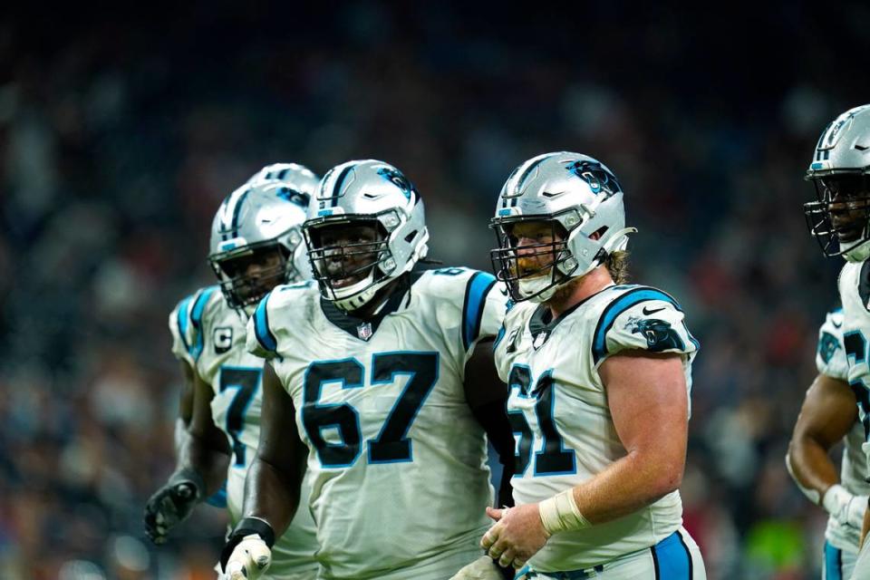 Carolina Panthers offensive lineman including Matt Paradis (61) and John Miller (67) break the huddle during an NFL football game against the Houston Texans, Thursday, Sept. 23, 2021, in Houston. (AP Photo/Matt Patterson)